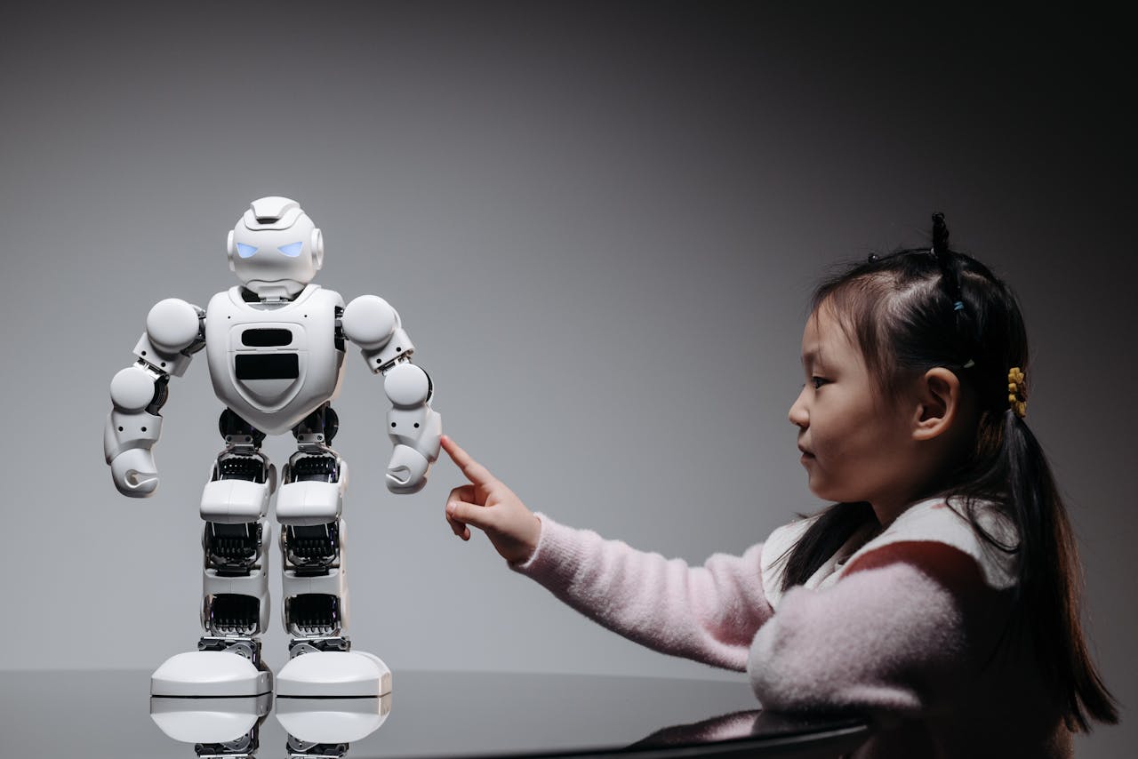 who-we-are A young girl engaging with a robotic toy, highlighting curiosity and innovation.
